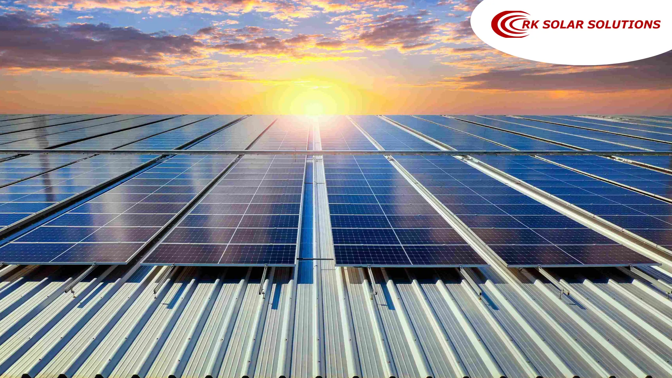 Solar panels on a metal roof at sunrise